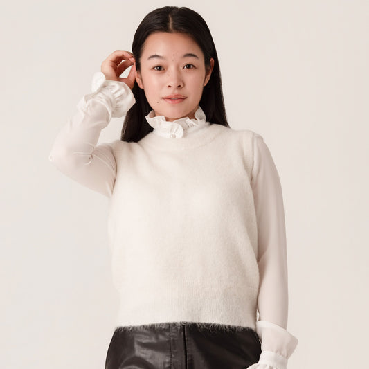 Woman wearing a white alpaca and wool tank sweater