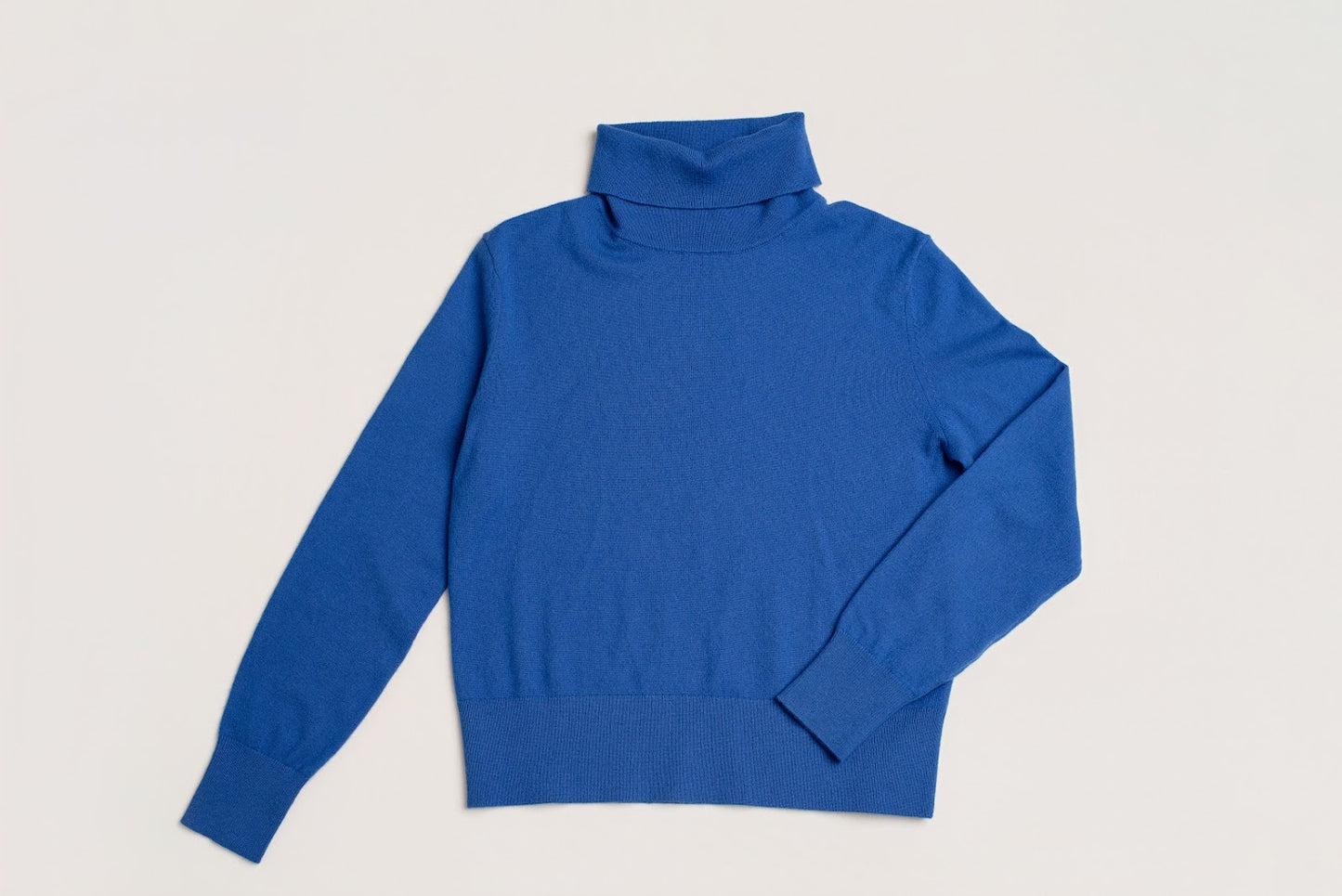 bright blue wool and cashmere polo neck laid flat
