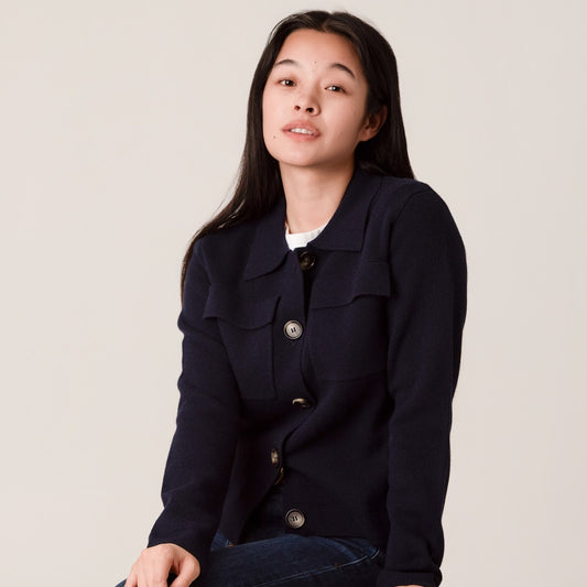 Person wearing a navy blue button up wool jacket