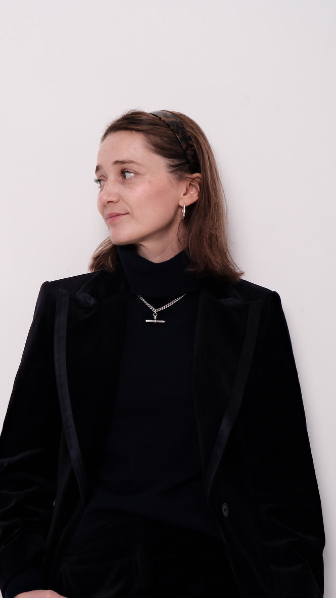 Woman wearing a black outfit with a white background