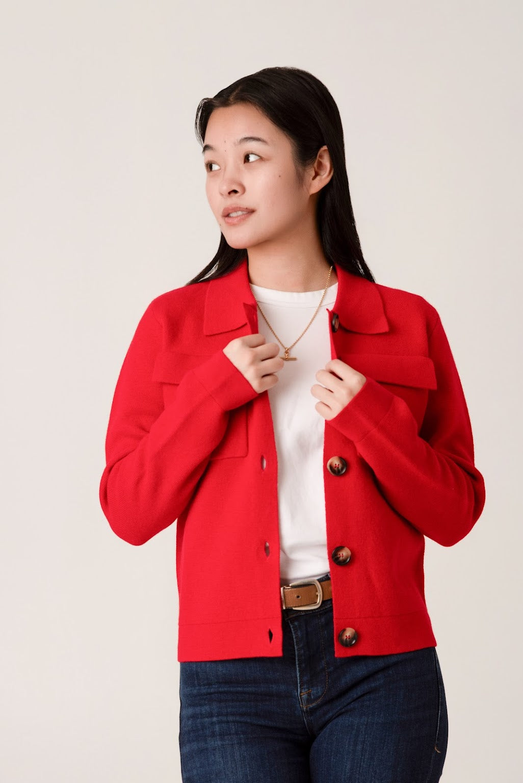 Woman wearing a red wool jacket over a white t-shirt 