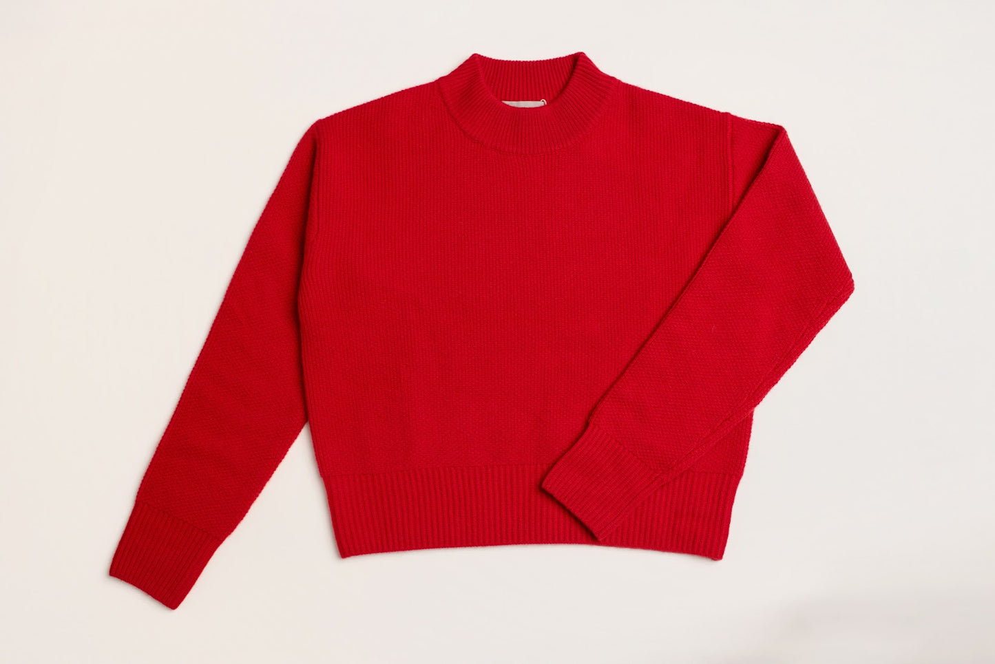 red wool and cashmere sweater laid flat