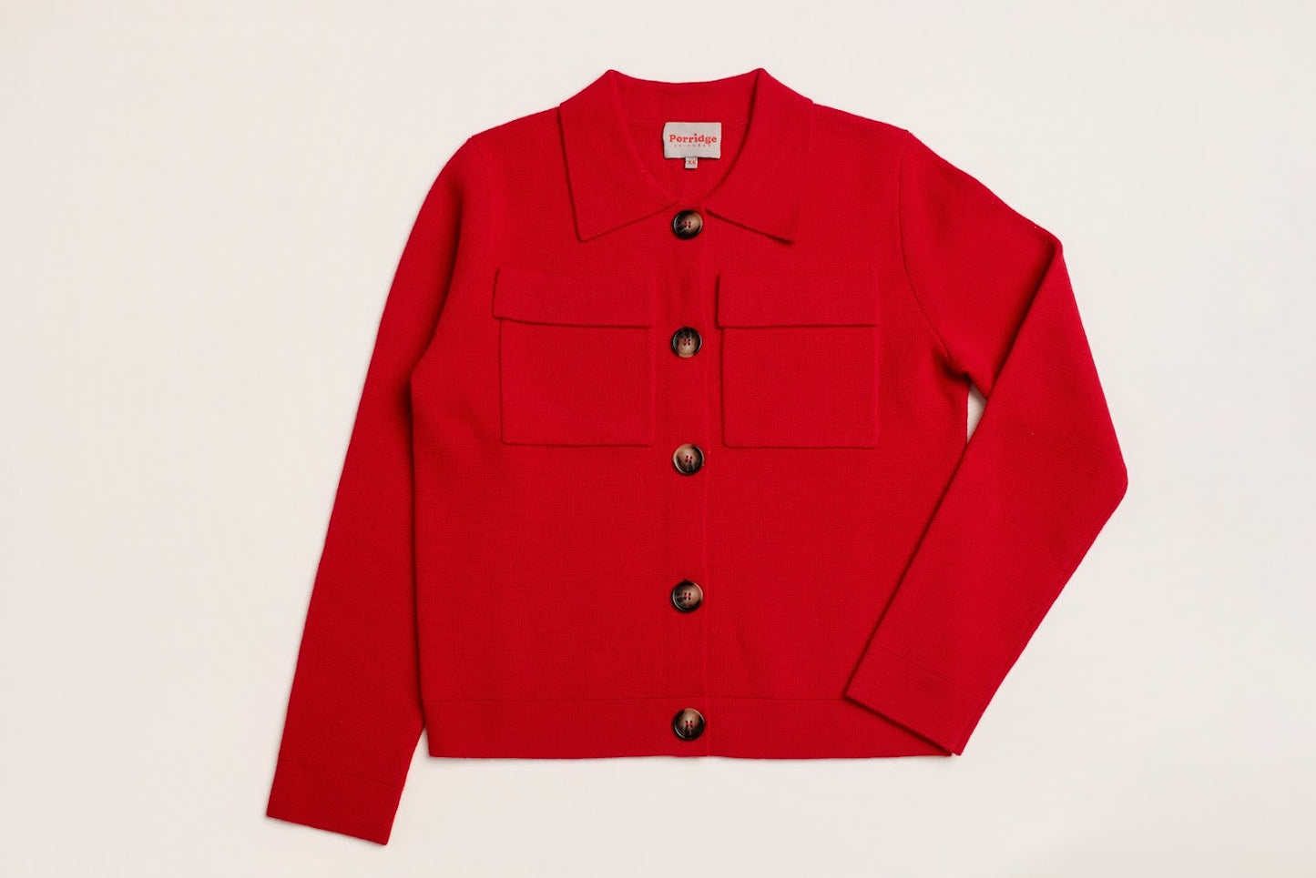Red wool jacket with tortoiseshell button details laid flat