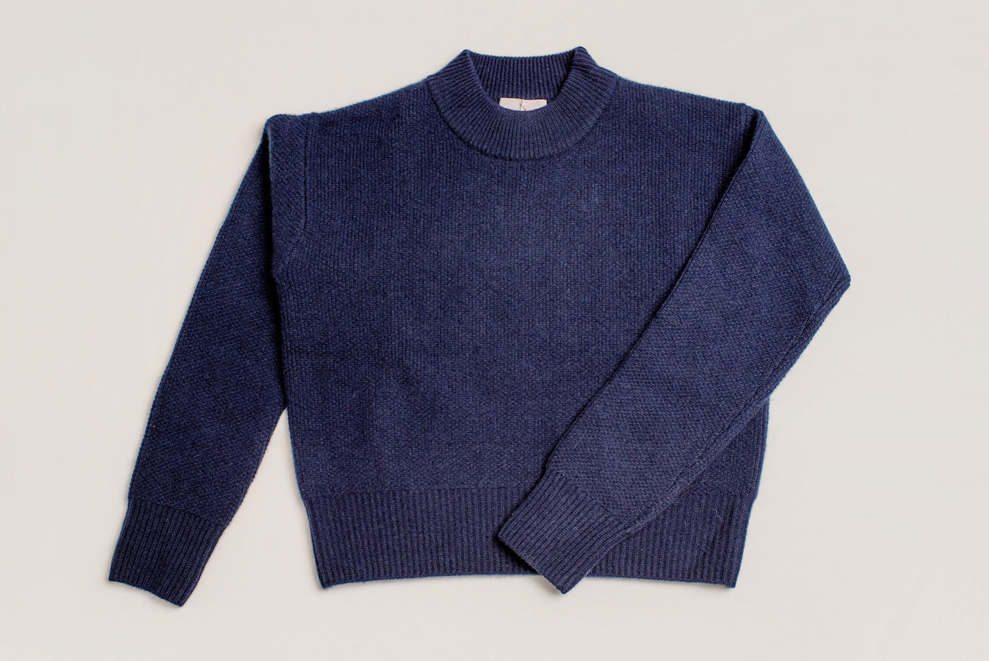 The cosiest and warmest Navy cashmere jumper laid flat
